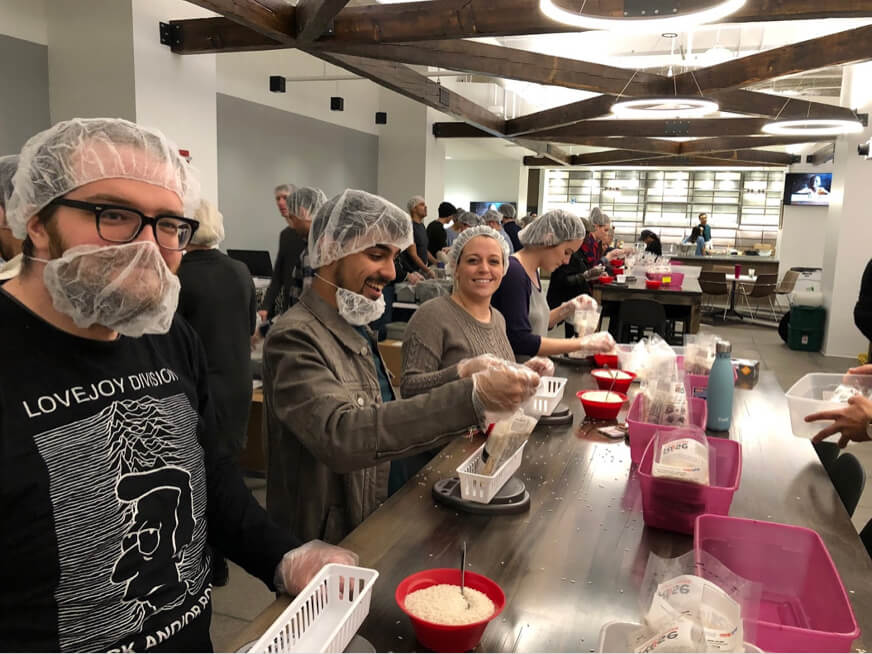 group of people assembling crafting kits