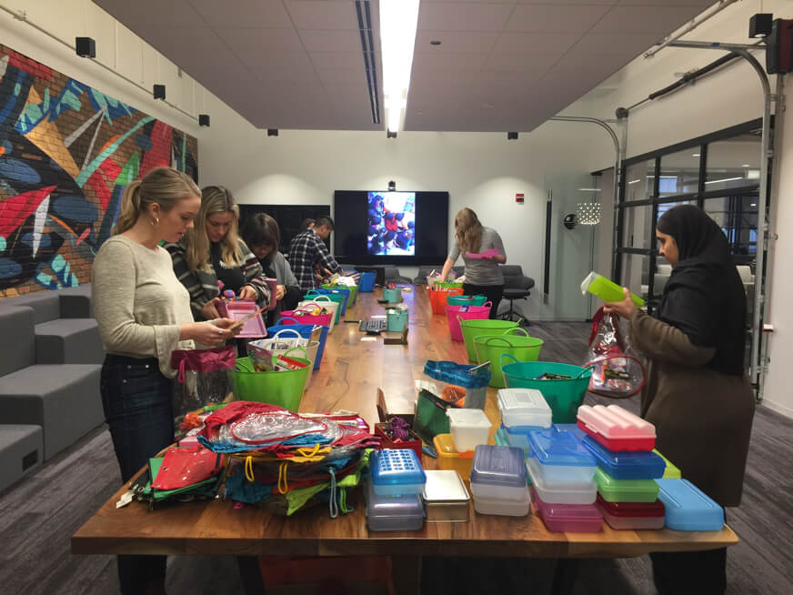 group of people assembling crafting kits